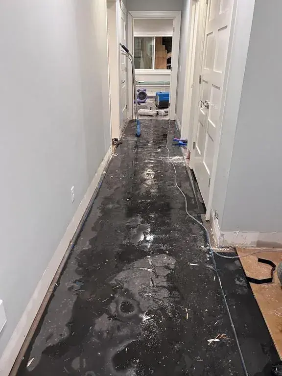 Standing water on a basement floor after a sump pump failure