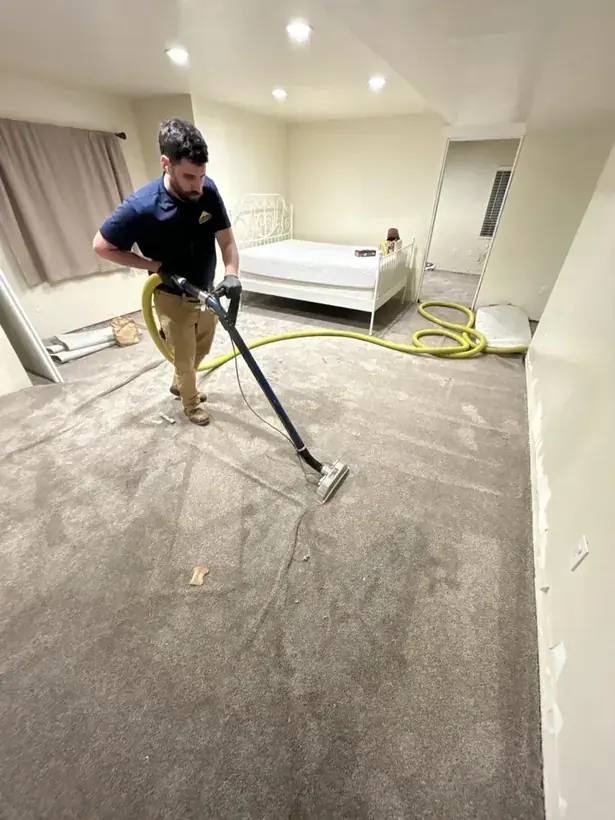 Technician extracting standing water from an Alpine floor